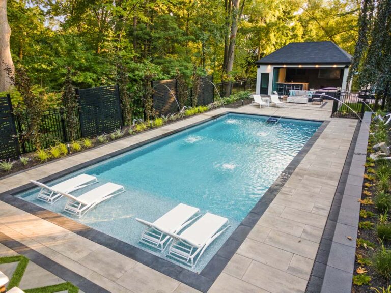 Luxurious outdoor space with a pool, patio, and elegant landscaping