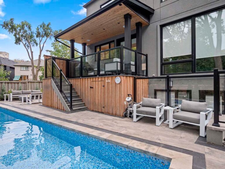 Luxurious backyard featuring a pool and elegant lounge chairs