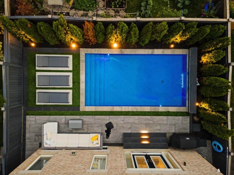 Backyard with a wooden deck and lush landscaping