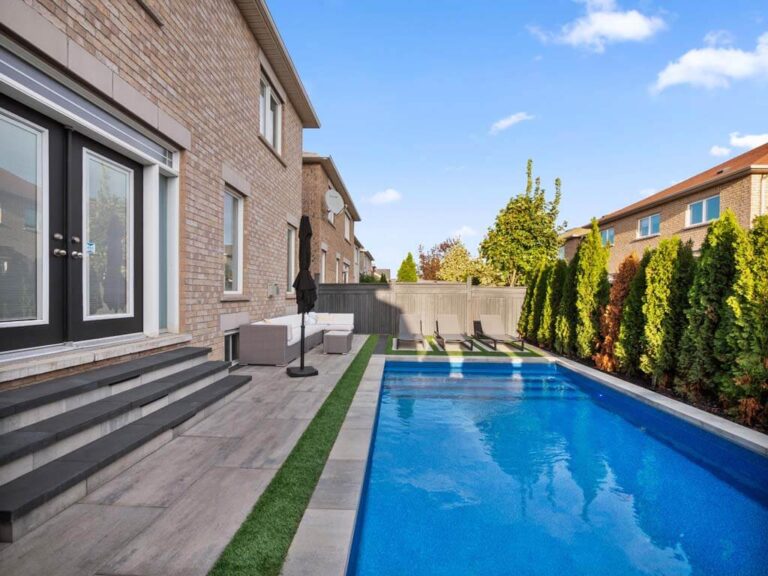 Backyard with a stone pathway and green lawn