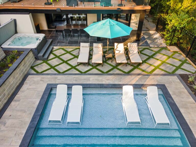 Stylish outdoor dining area with a modern table, chairs, and ambient lighting