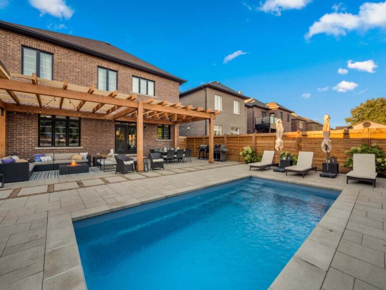 Backyard with wooden deck, seating, and garden