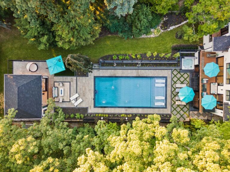 Cozy backyard with a stone patio, fire pit, and comfortable seating