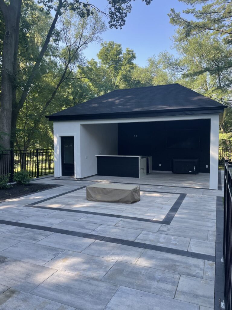 Outdoor living area with a stone fireplace and cozy furniture