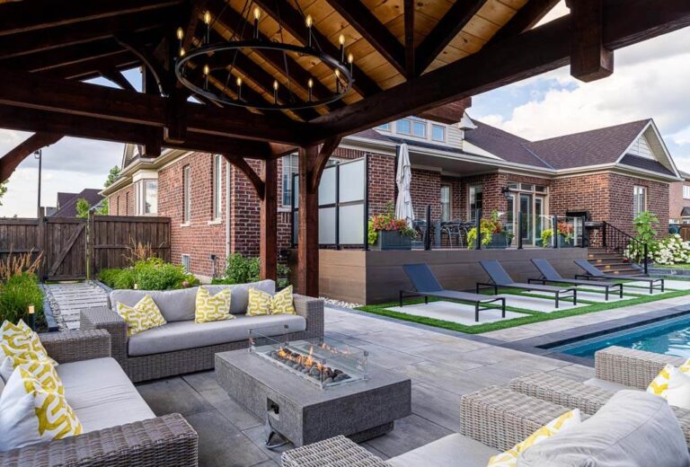 Inviting backyard patio with stone flooring, garden features, and comfortable seating