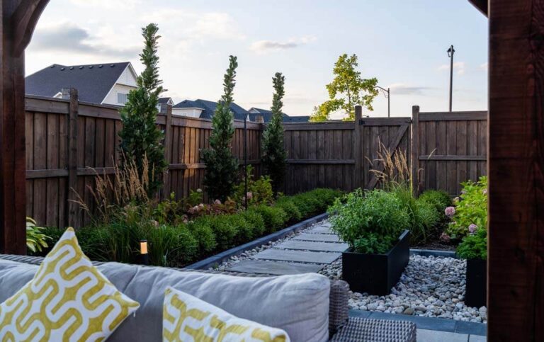 Outdoor living space with a pergola, wooden deck, and garden elements