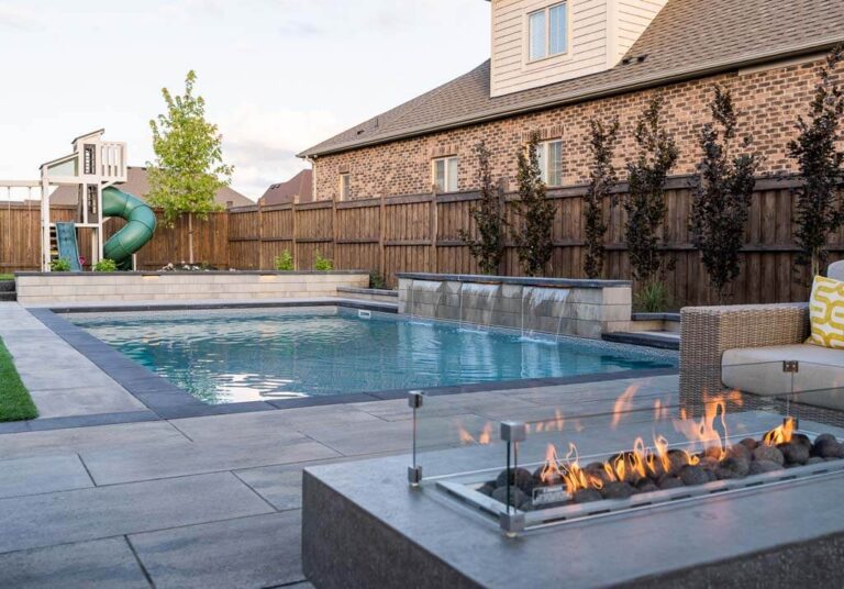 Spacious backyard with a mix of stone and grass areas, designed for relaxation