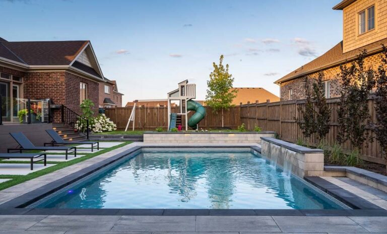 Contemporary backyard design featuring a stone pathway and vibrant garden beds