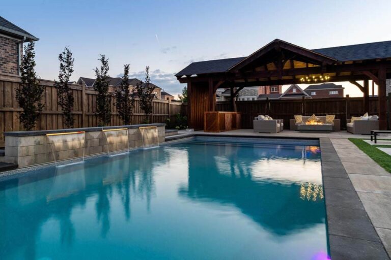 Elegant outdoor dining area with wooden furniture and surrounding garden