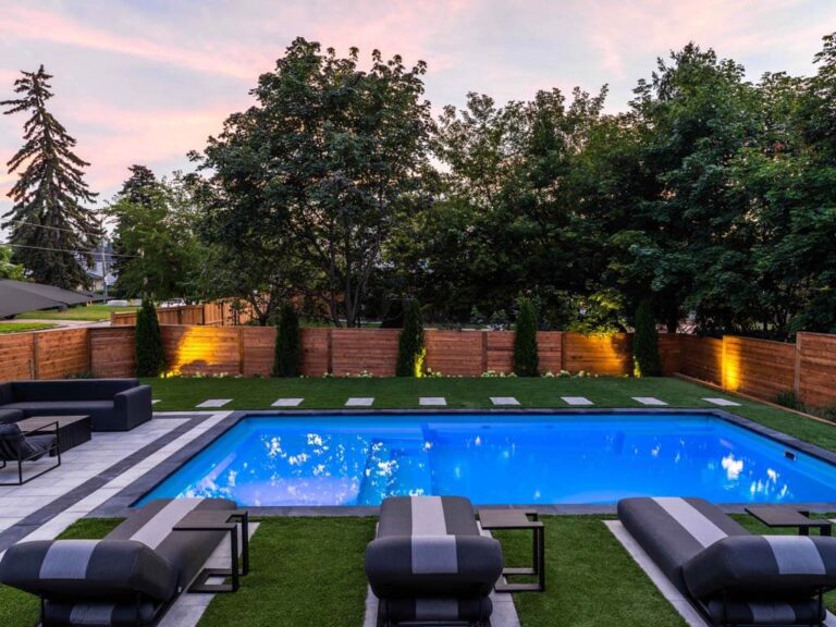 Elegant backyard with a large wooden deck and outdoor furniture