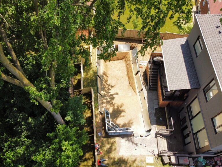 Stylish backyard featuring a mix of lawn and hardscaping