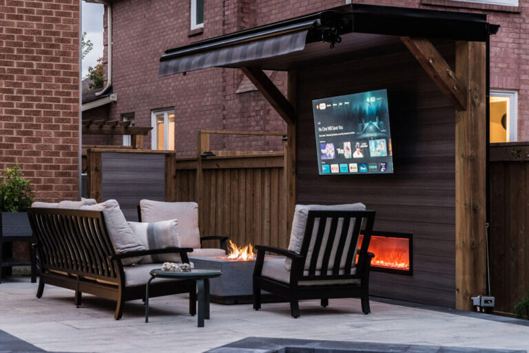 Backyard landscaping featuring a stone retaining wall