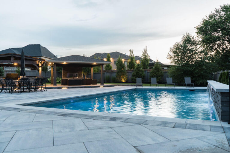 Stone patio with outdoor dining area and decorative plants