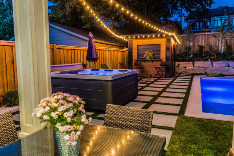 Modern backyard patio with a wooden deck and outdoor furniture
