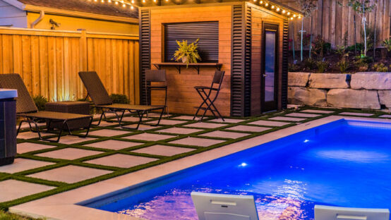 Stone patio with outdoor dining furniture and greenery