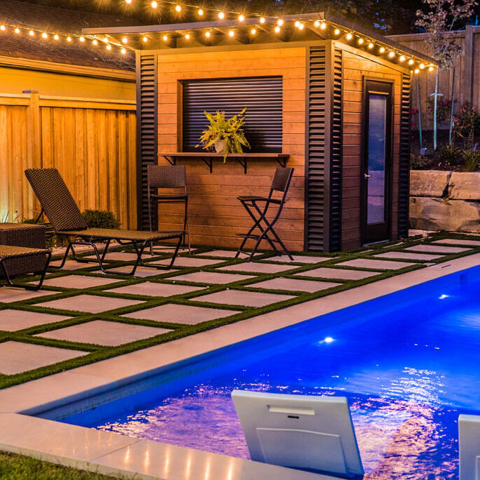 Stone patio with outdoor dining furniture and greenery