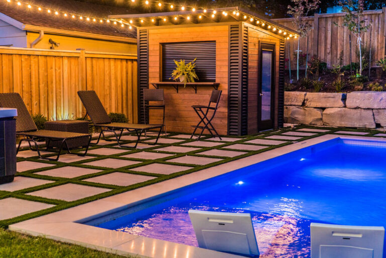 Stone patio with outdoor dining furniture and greenery
