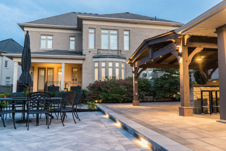 Spacious backyard with lush green lawn and stone pathway