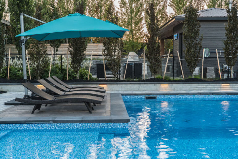 Cozy outdoor seating area with a fireplace and lush greenery