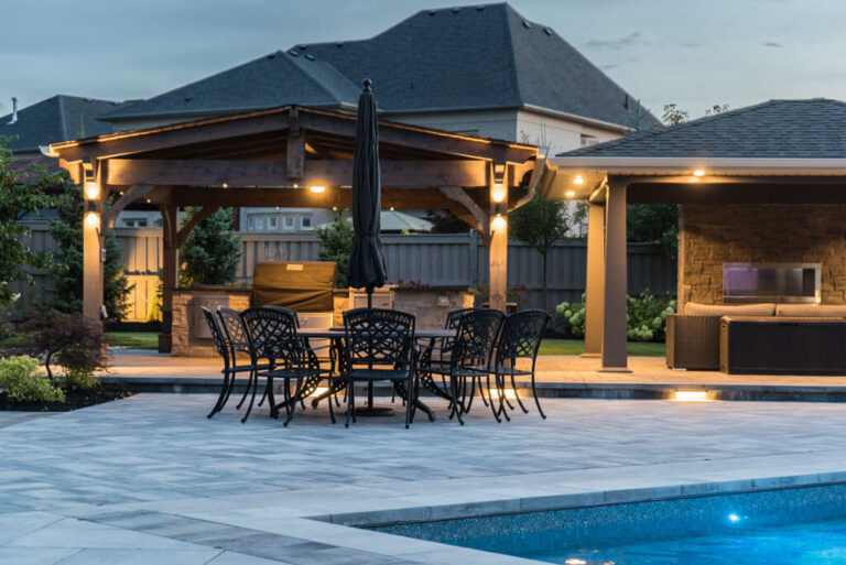 Beautifully designed backyard with a stone patio and seating area