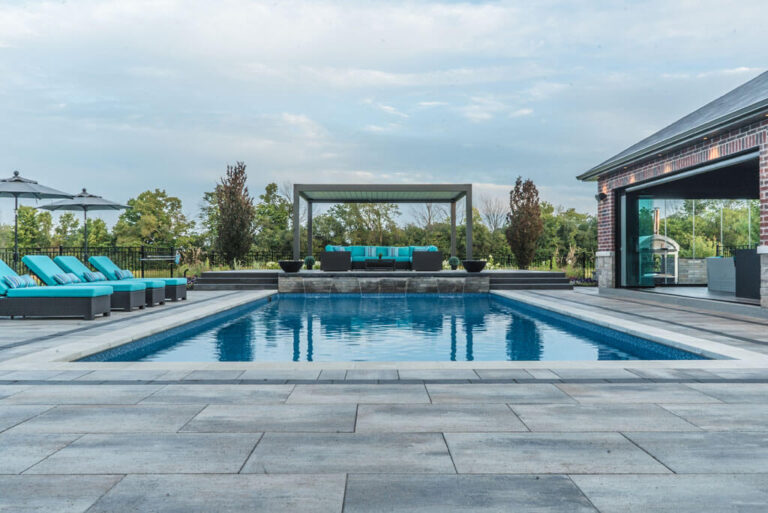 Beautifully Designed Pool with Water Features and Lounge Chairs