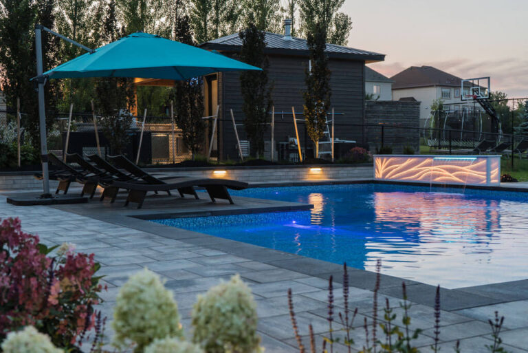 Contemporary backyard design with water feature and seating