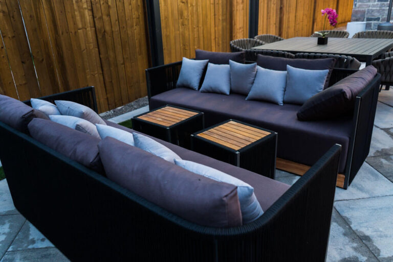 Nighttime view of illuminated backyard pool and garden