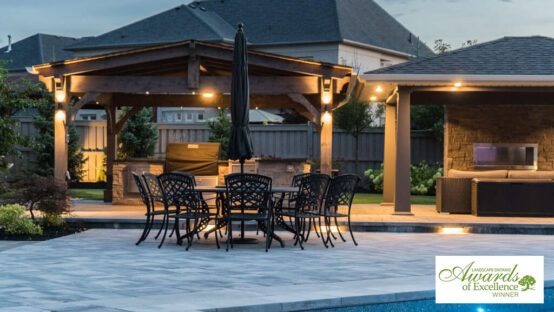 Beautifully designed backyard with a stone patio and seating area