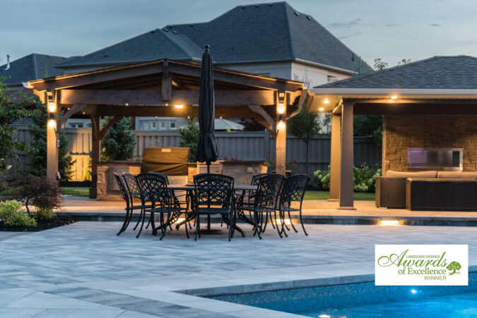 Beautifully designed backyard with a stone patio and seating area