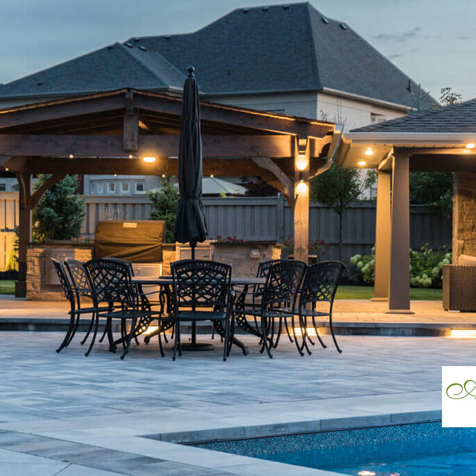 Beautifully designed backyard with a stone patio and seating area