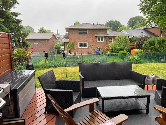Covered backyard deck with outdoor furniture built by Land-Con in Toronto