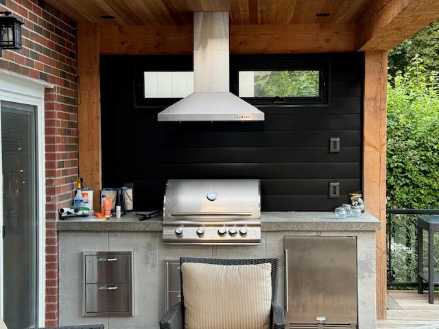 Covered outdoor kitchen with built-in grill installed by Land-Con in Toronto
